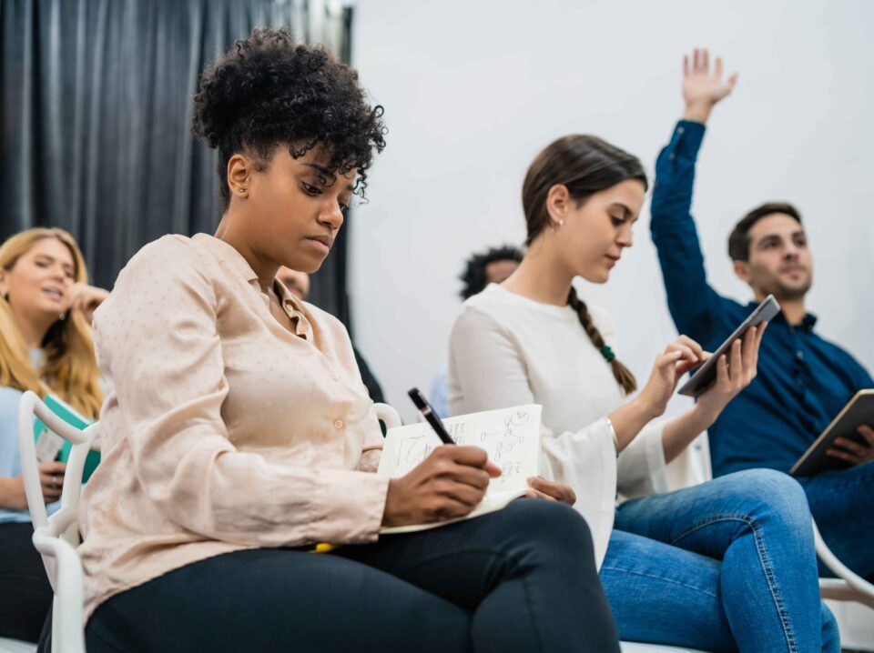 group-young-people-sitting-conference-together-while-raising-their-hands-ask-question-business-team-meeting-seminar-training-concept (1)